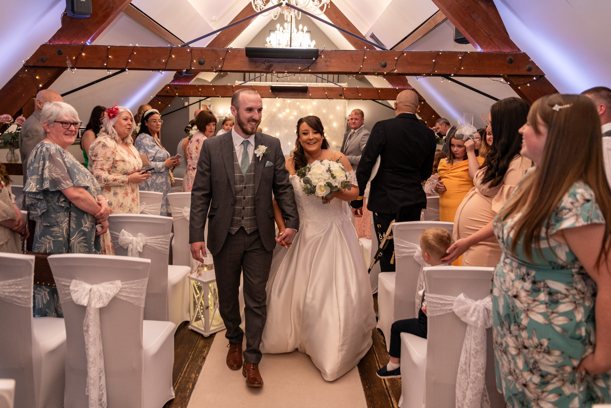 Bride and Groom exiting from their ceremony at The Barns Hotel Cannock