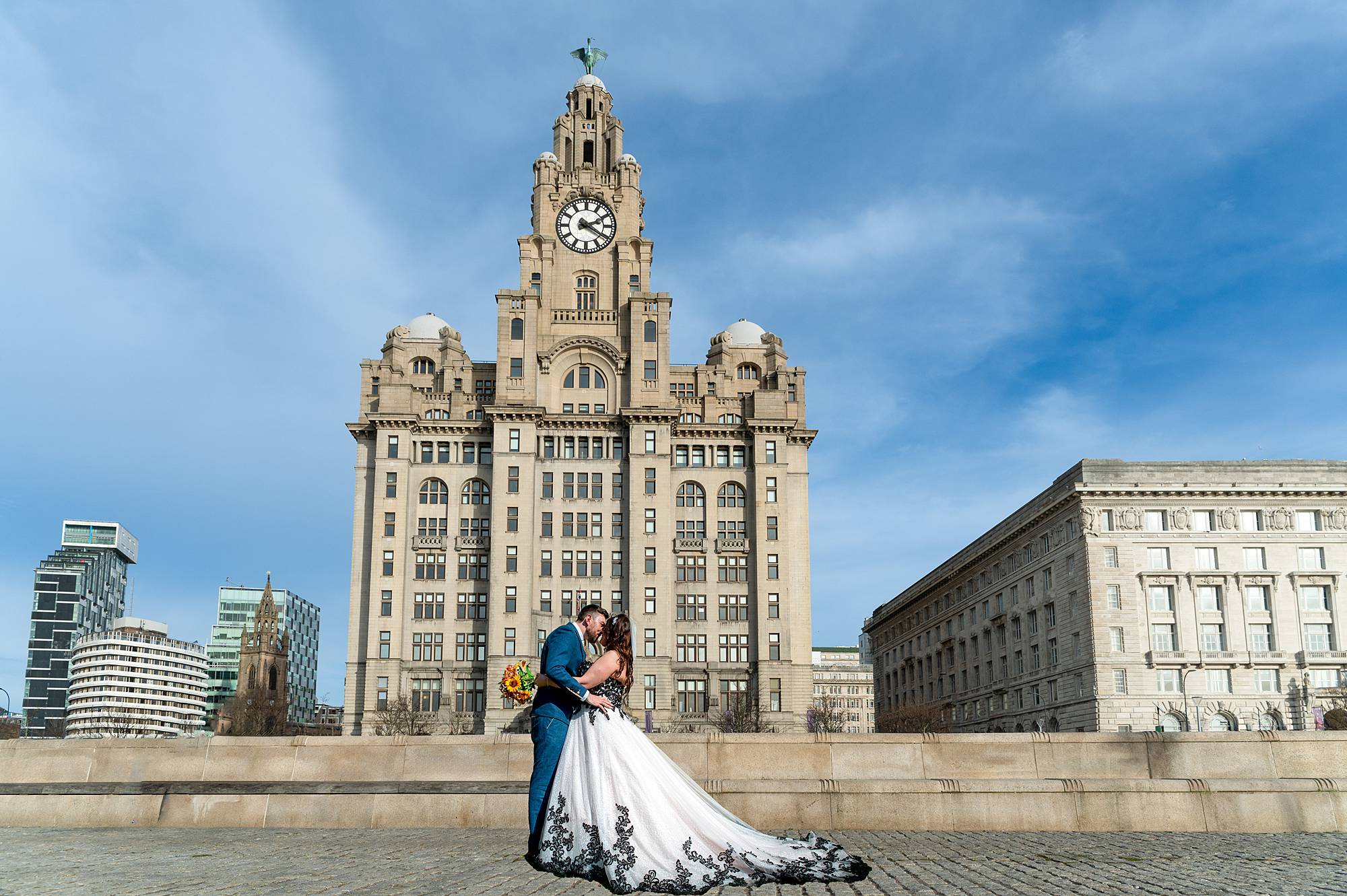 Newly-wed couple outside Liverpool Liver Building