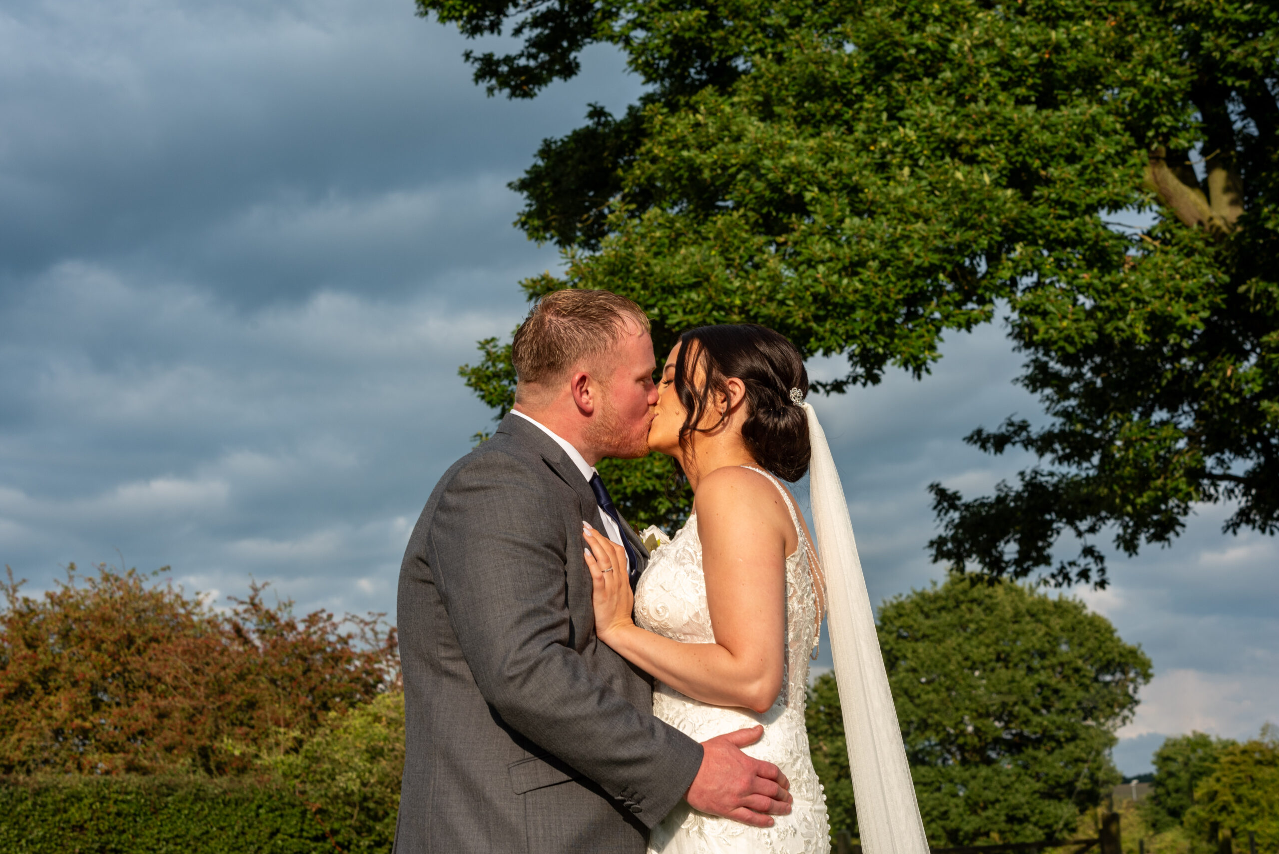 Newly-wed couples portrait in the summer sun at Oak Farm Hotel in Cannock